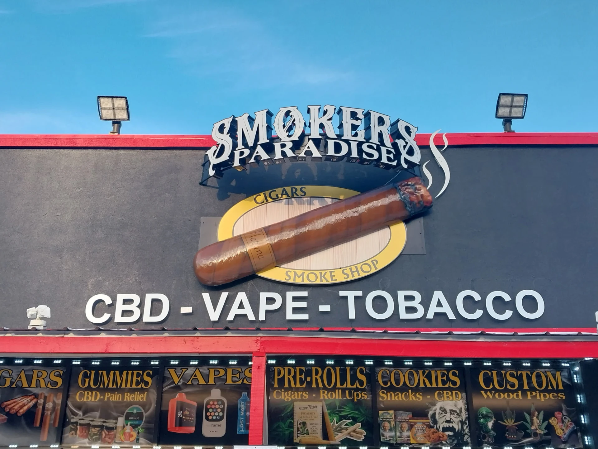 Smokers Paradise storefront at night
